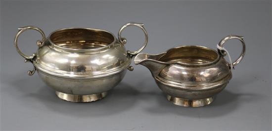 A George V silver two handled sugar bowl and matching cream jug, Birmingham, 1919.